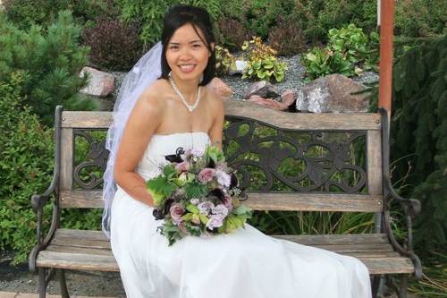 bridal bouquet with bamboo branches, fern curls, Schwartzwalder mini callas, Amnesia roses, Eloquence spray roses, scabiosa pods, seeded eucalyptus, cymbidium orchids and scented geranium