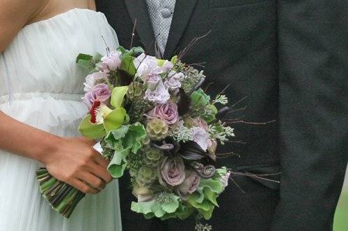 bridal bouquet with bamboo branches, fern curls, Schwartzwalder mini callas, Amnesia roses, Eloquence spray roses, scabiosa pods, seeded eucalyptus, cymbidium orchids and scented geranium