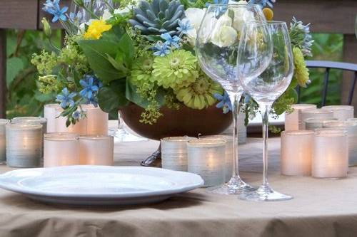 centerpiece that doubles as an aisle arrangement with hydrangea, iris, cymbidium orchids, stock, peacock feathers, scented geranium and seeded eucalyptus