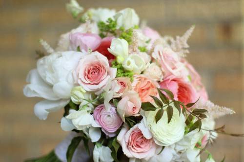 Bridal Bouquet with Eucharis lilies, ivory mini callas, white peonies, white sweet peas, white sweetheart roses, white and green mini cymbidiums, green hydrangea, Super Green roses, Green Trick dianthus, alchemilla, and scented geranium