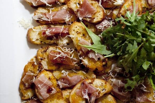 Prosciutto & fig crostini with garden greens.A beautiful & delicious hors d'oeuvre.