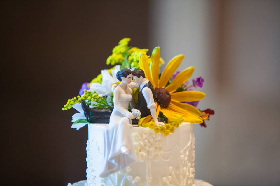 Flowers behind cake toppers