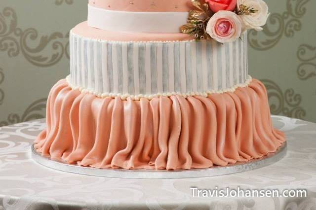 Classic romance: 5 tiered wedding cake featuring draping, vertical stripes, quilting, hand piped brushed embroidery, and hand piped scroll work finished with fresh floral accents.