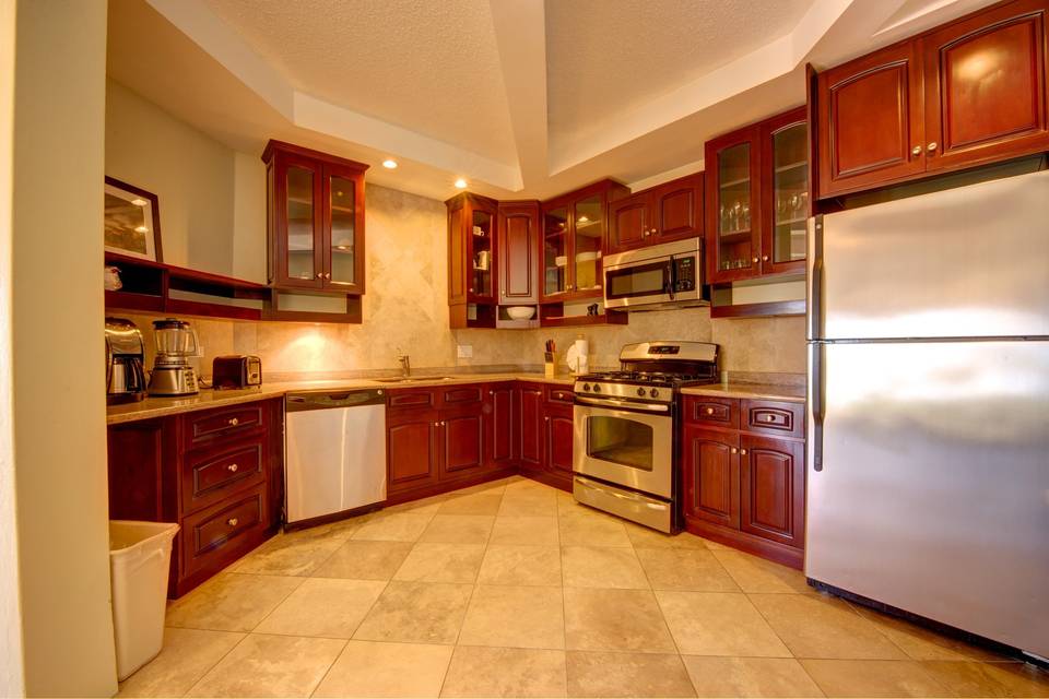 The kitchen space of a one-bedroom suite. All rooms are unique in their configurations but all one-bedroom suites offer separate living space, kitchen, extra bathroom, washer/dryer and other amenities.