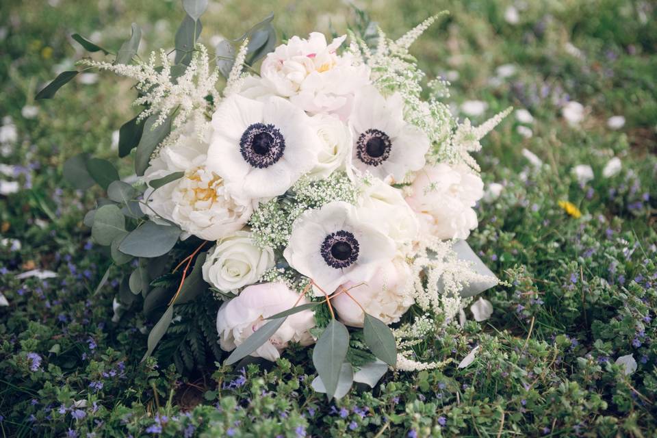 Mixed floral bouquet featuring anemone.