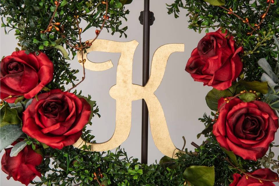 Closeup of wedding decor with roses and gold letter
