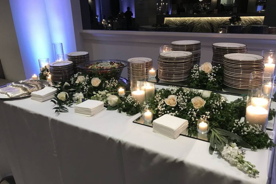 Table setup with candle and flower centerpiece