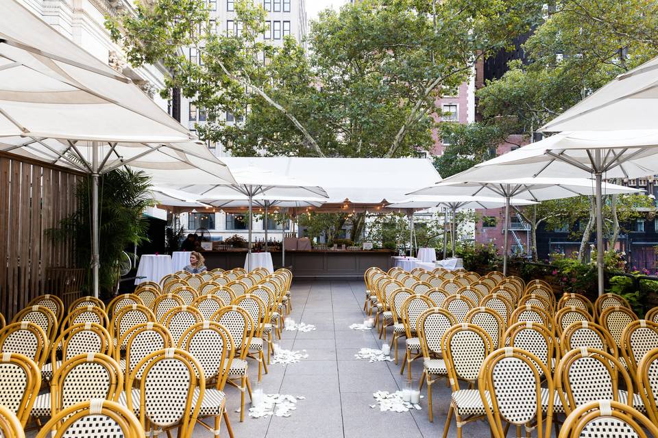 Rooftop ceremony with bar in the background