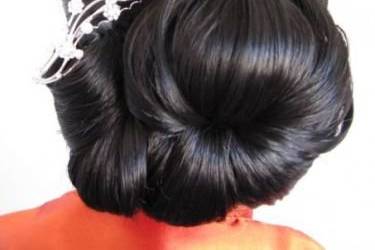 a very ornate updo with a decorative comb