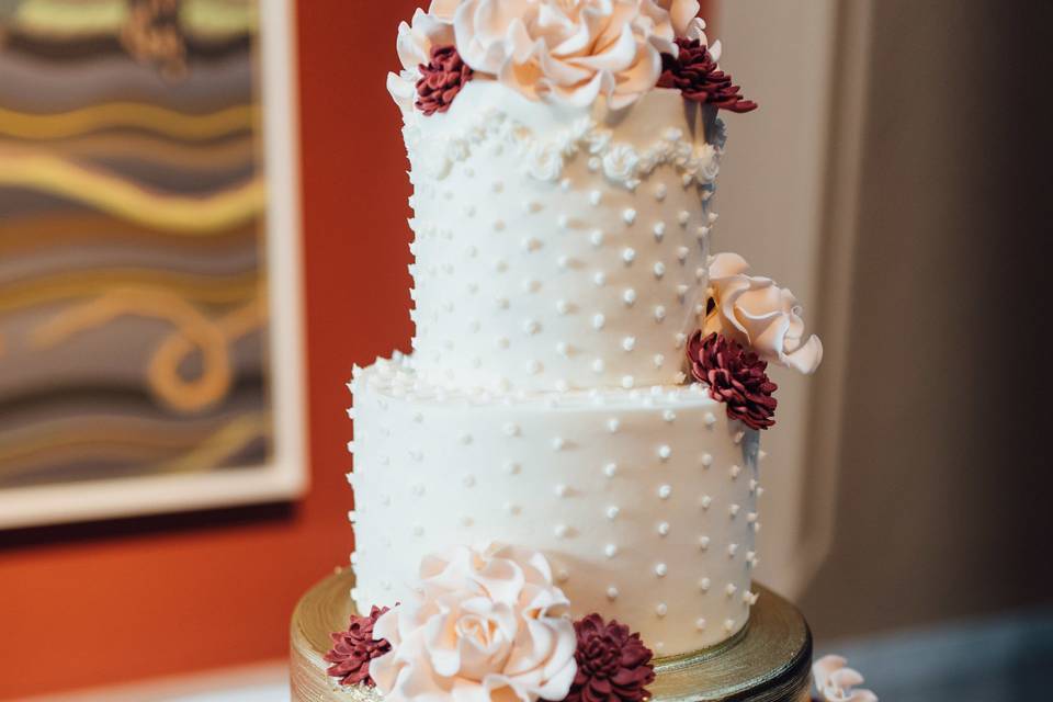 White and gold cake with flowers