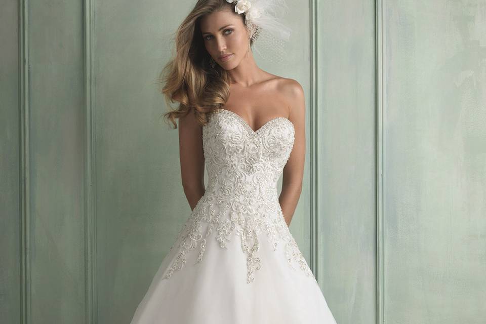 Allure Bridals gown style 9121.  This strapless ballgown features layers of airy English net covered with lace appliqué.