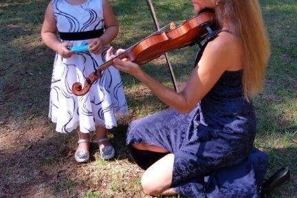 Violinist playing for a child