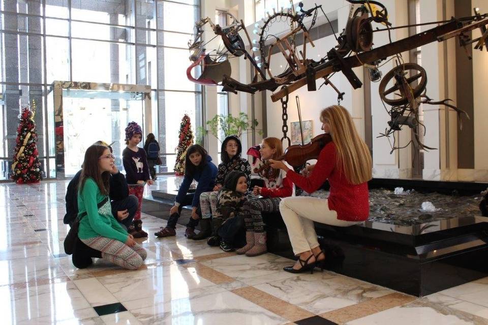 Violinist performing for kids