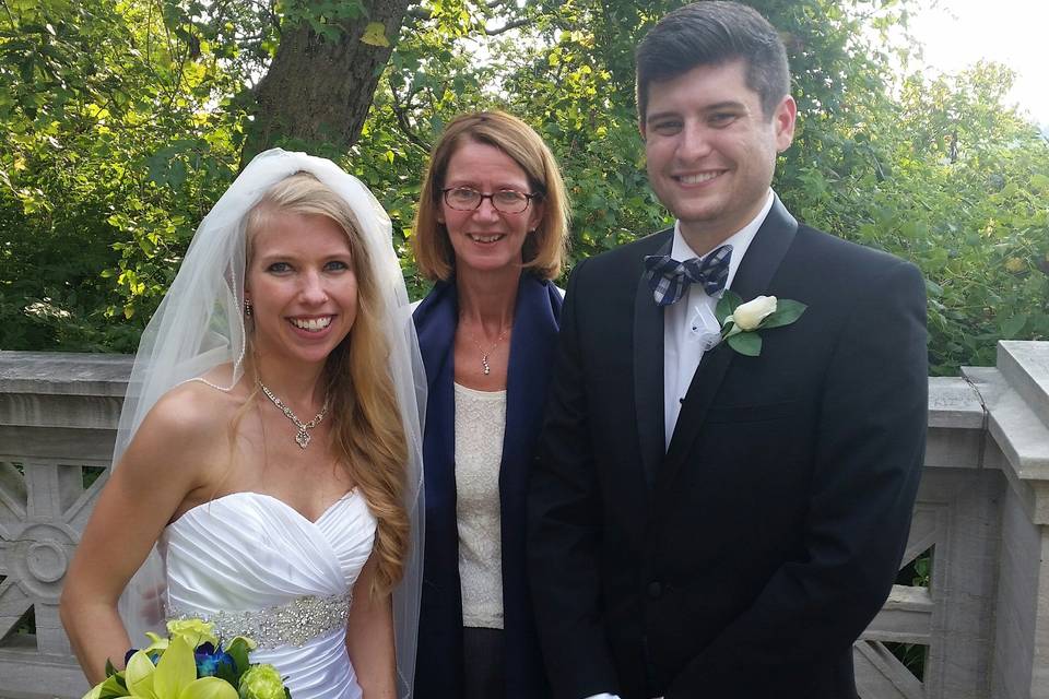 Happy newlyweds and officiant