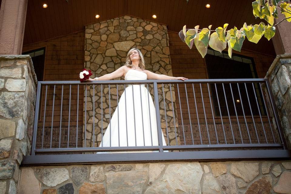 A beautiful bride looking out from the balcony