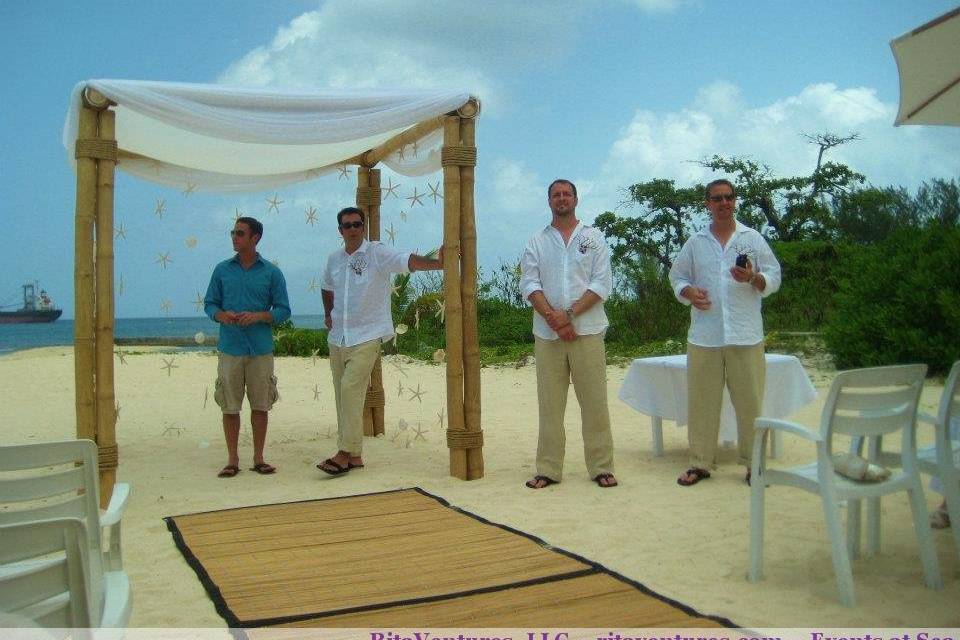 The guys all ready to go. A great view of the bamboo canopy with starfish and shells hanging. Also a great view of the aisle runner--wasn't too necessary as the sand was cool enough for the girls to walk barefoot down.