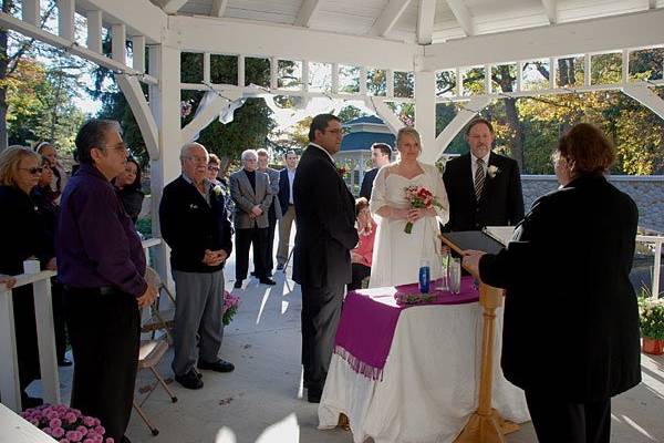 Rev. Misty Urban welcomes friends and family at Molly and Norbert's wedding ceremony. Their marriage vows took place at the Serenity Garden pavilion in Grand Rapids, Michigan. Photo copyright 2010 by GRWeddingOfficiant.com