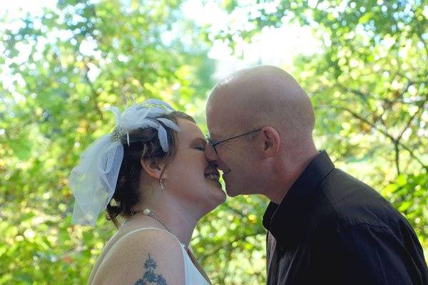 Dannial and Duncan share a kiss as the pose for photos after their elopement ceremony at the GRWeddingOfficiant.com wedding chapel in Grand Rapids, Michigan. Photo copyright 2010 by GRWeddingOfficiant.com