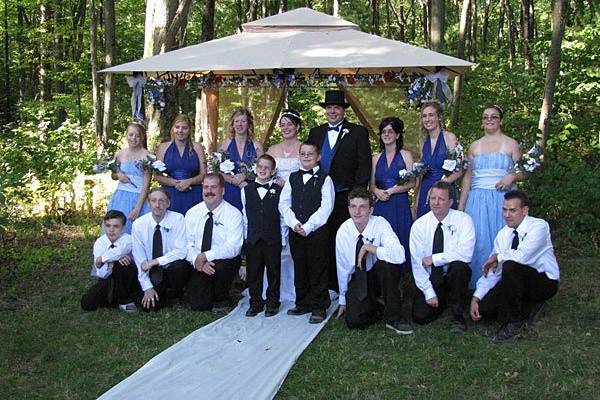 Bill and Theresa's entire wedding party pose for a photo memory of the handfasting wedding ceremony. Photo copyright 2009 by GRWeddingOfficiant.com