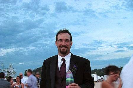 The best man holds the finished vase from the Blending of the Sands ceremony at Rob and Tricia's beach wedding in Grand Haven, Michigan. Photo copyright 2010 by GRWeddingOfficiant.com