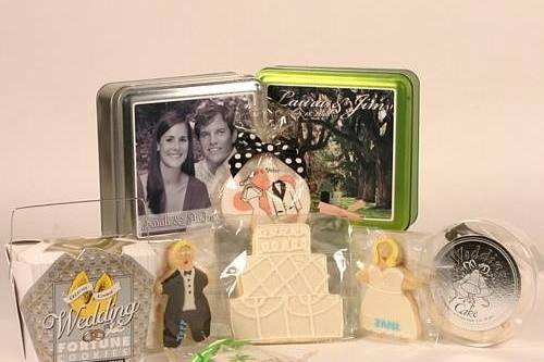 What could be more fun for your wedding than some cute and tasty cookies? We can offer personalized decorated sugar cookies in just about any shape and color, like the bride and groom cookie, a wedding cake cookie - whatever shape cookie you can dream up! We also work with a great company that puts your photo and message on a tin filled with delicious cookies in a host of flavors. Another of our favorite companies makes themed fortune cookies for every occasion, the Wedding Fortune Cookies make a great favor and can be personalized. A minimum order of 300 cookies could also have a special personalized message inside the cookie. The microwave wedding cake could also be a fun and unique way to send your guests home with their own piece of cake.
Mentioned in the New York Times Style Section (June 2003), our wedding gifts have been selected by some of the top wedding planners in Manhattan. Whether for a wedding gift, reception favors, bridal shower gifts, wedding guests (particularly for those out-of-towners staying in hotels!) or for your lucky bridal party, we will create something unique and distinctive for you.
Just tell us your theme and a budget and put yourself in our hands.  Call us at 212-627-4050 or email us at sales@thegiftedones.com