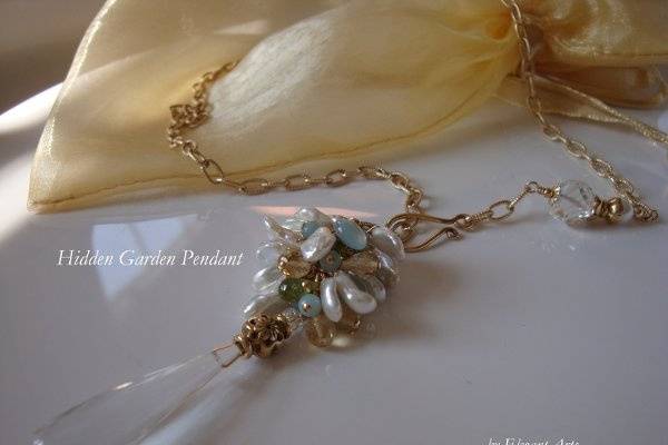 Hidden Garden Pendant - Crystal Quartz
This pendant features an elongated crystal quartz teardrop suspended from a cascade of lustrous keish pearls with a 