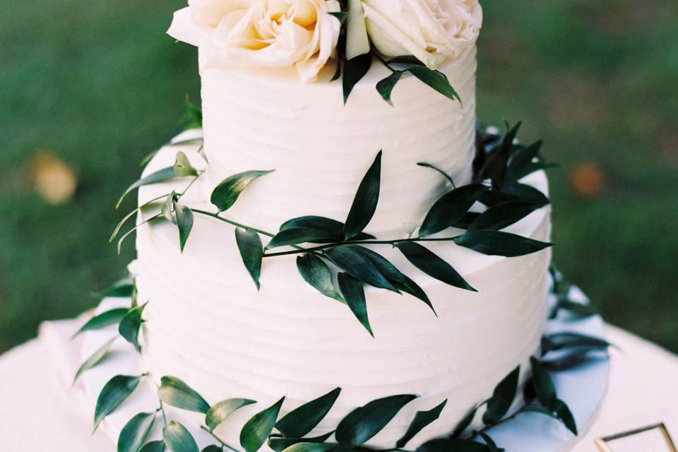 Simple 2 tier white cake with greenery and roses