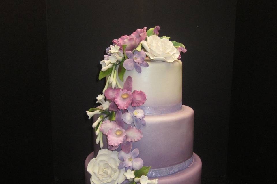 3 tier Lavendar Ombre cake with fondant and sugar flower cascade