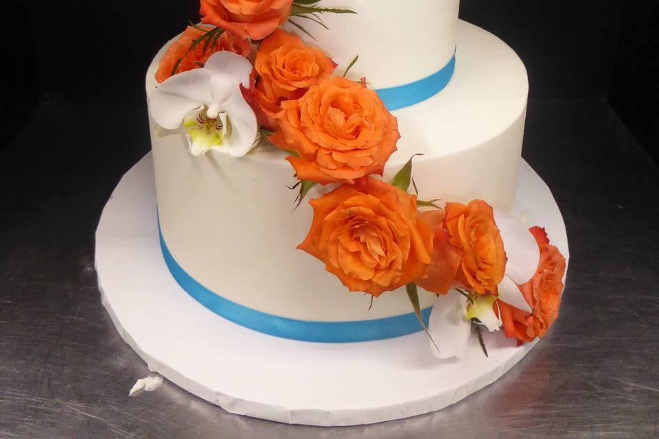 Simple 2 tier buttercream with fresh orange roses and moth orchids