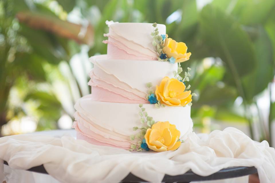 3 tier fondant with blush ruffles, yellow and blue sugar flowers