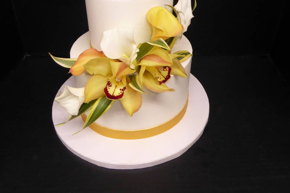 Simple 2 tier buttercream with fresh yellow Cymbidium and Calla lily flowers