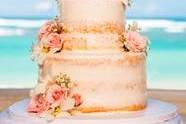 Semi naked cake with fresh pink flowers and Love cake topper