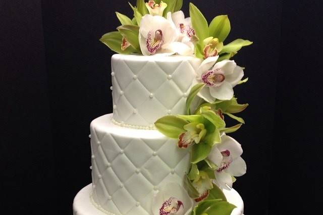 3 tier fondant cake with quilting and white and green Cymbidium orchids