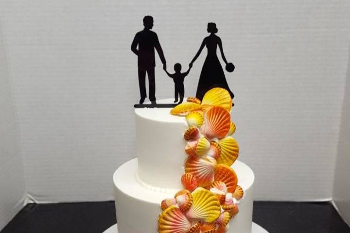 2 tier fondant cake with sugar sunrise shells and cake topper