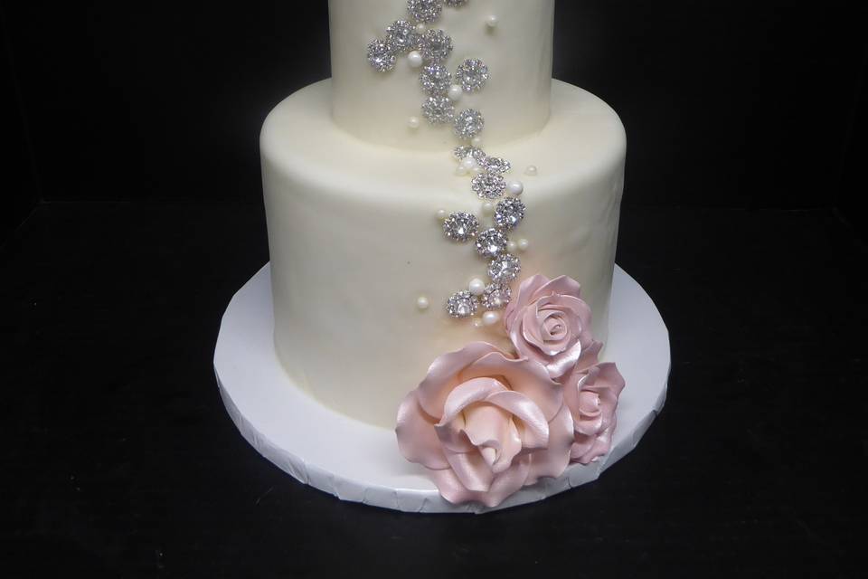 2 tier fondant cake with pink sugar roses and silver rhinestone jewel adornments