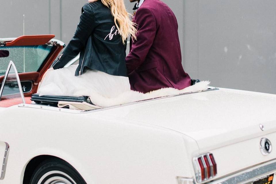 Couple sitting on white convertible