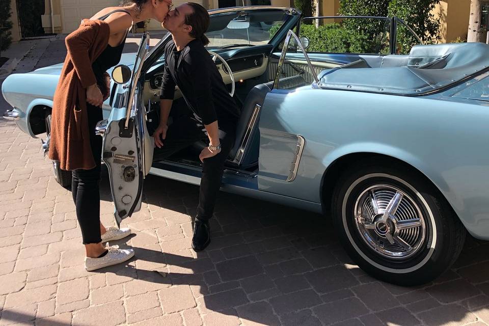 Couple kissing in blue convertible