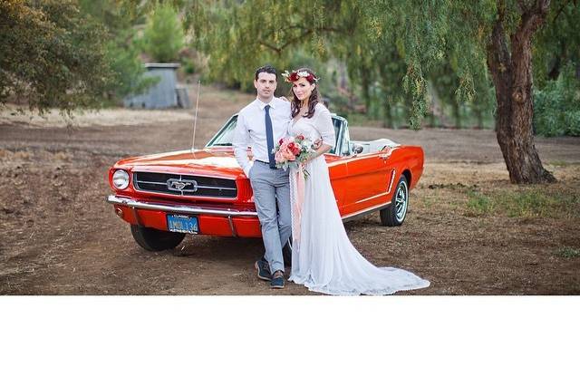 Couple posing with red convertible