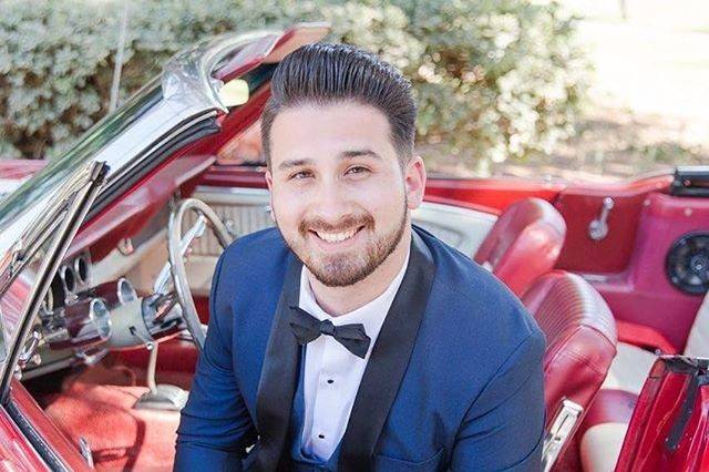 Man sitting in red convertible