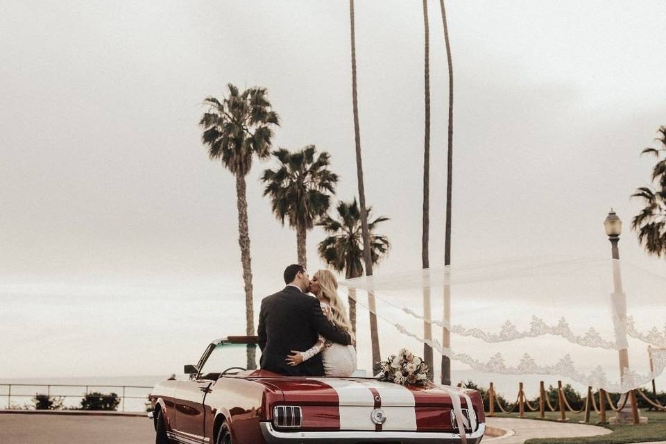 Couple kissing on vintage car