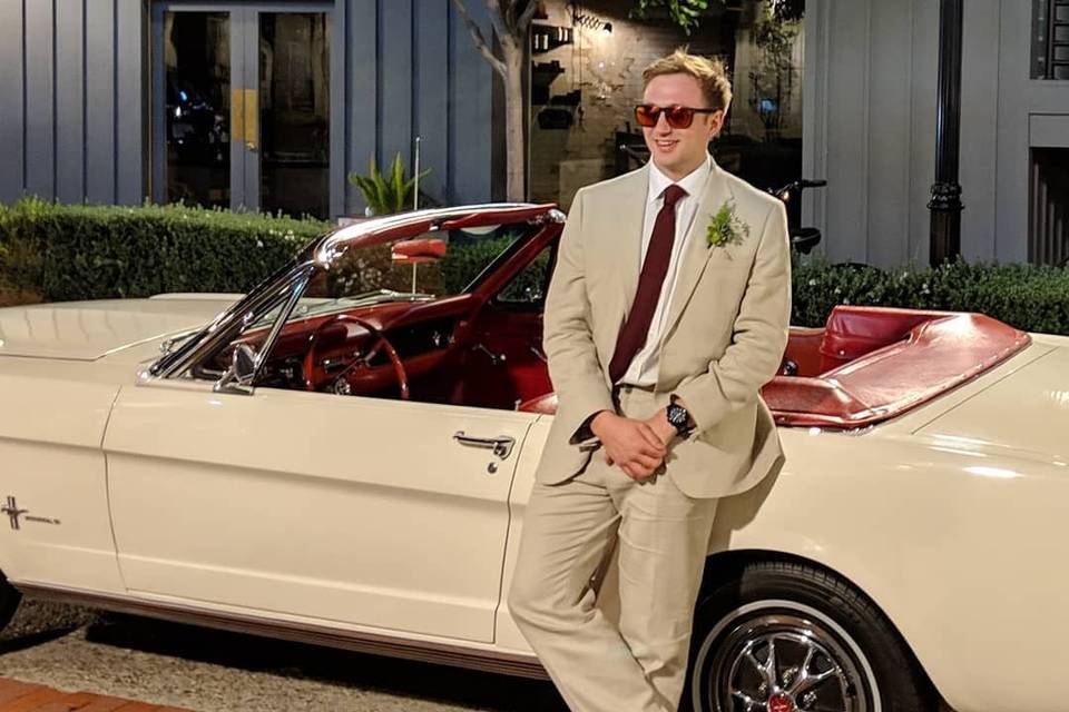 Man posing with vanilla mustang