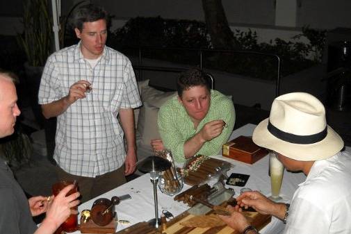 Guests at a bachelor party enjoy one of our cigar rollers making cigars by hand while he explains a few tricks of the trade.