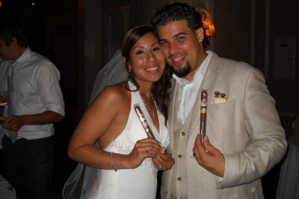 The Happy Couple holding their Wedding Cigars.  Many couples save a few cigars to enjoy on their anniversary.