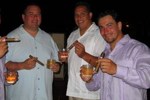 Wedding guests enjoying freshly rolled Don Pedro Cigars with special blends and tobacco from Puerto Rico.