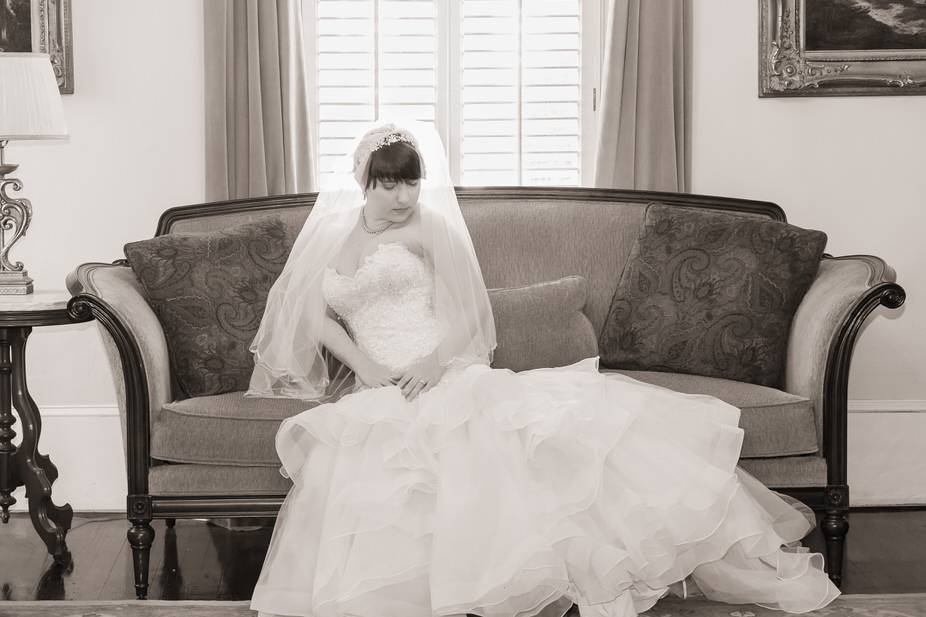 Bride seated on a couch - John Marquez Photography
