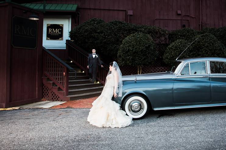 Bride standing in front of a classic car - John Marquez Photography