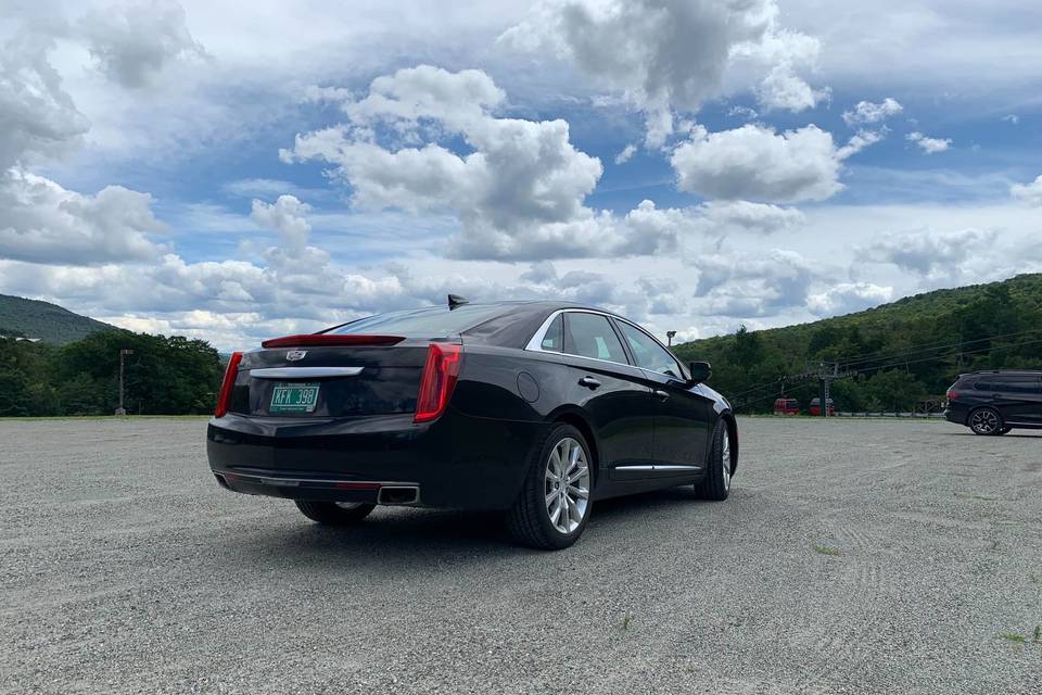 Black sedan in parking lot