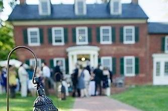 Nole & Andrew hold cocktail hour in front of the Georgian-style Woodlawn Manor house.  Photo by Punam Bean.