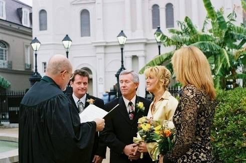 Chaplain Schwehm and couple gettting married in Jackson Square, New Orleans