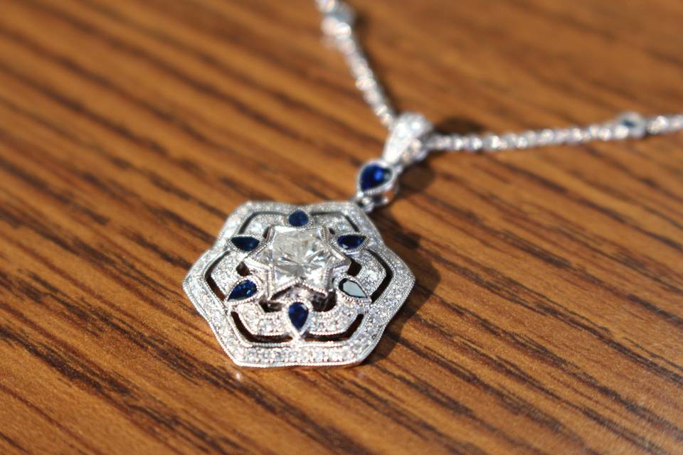 This pendant was designed to embrace a 2 carat diamond 